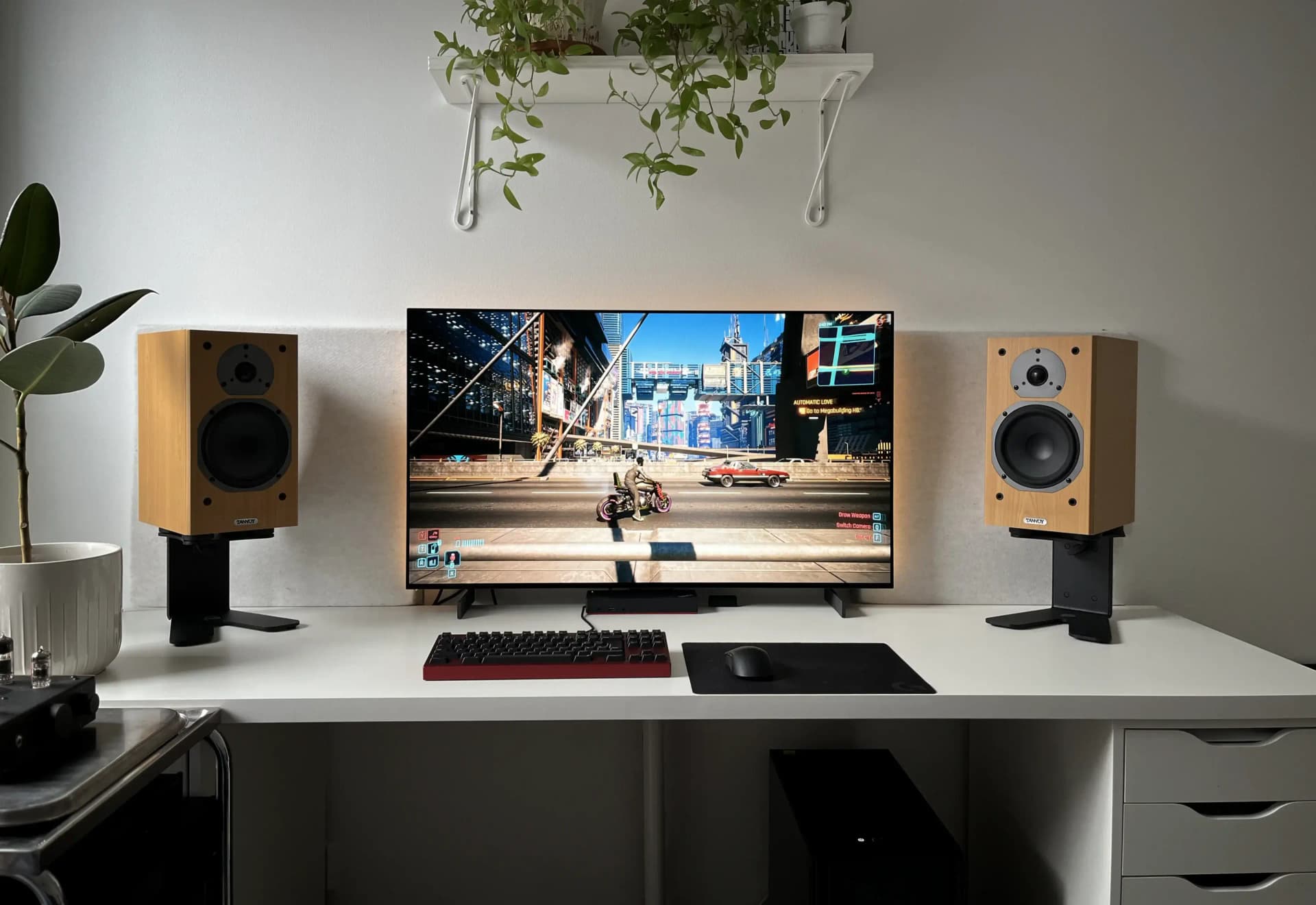 White minimalist gaming setup with high-quality audio equipment